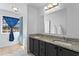 Main bathroom featuring double sinks, vanity, granite countertops, and large mirror at 392 Fourth St, Forest Park, GA 30297
