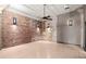 Empty bedroom featuring exposed brick walls, hardwood floors, modern lighting, and plenty of natural light at 434 Marietta Nw St # 301, Atlanta, GA 30313