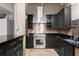 Modern kitchen with stainless steel appliances, black cabinetry, granite countertops, and a stainless steel range hood at 434 Marietta Nw St # 301, Atlanta, GA 30313