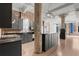 Kitchen with island and stainless steel appliances, modern cabinetry, and an industrial-style exposed brick wall at 434 Marietta Nw St # 301, Atlanta, GA 30313