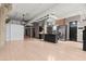Open floor plan with exposed brick, modern kitchen, and concrete columns at 434 Marietta Nw St # 301, Atlanta, GA 30313