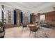 Bright living area features exposed brick, large windows, comfortable seating and area rug at 434 Marietta Nw St # 301, Atlanta, GA 30313