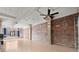 Open living space with exposed brick wall, concrete pillars, light hardwood floors, and many large windows at 434 Marietta Nw St # 301, Atlanta, GA 30313