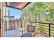 Private balcony with a seating area offering views of the trees and the surrounding neighborhood at 1250 Lupo Loop, Palmetto, GA 30268