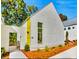 Modern white home with striking minimalist design and verdant landscaping provides curb appeal at 1250 Lupo Loop, Palmetto, GA 30268