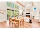 Bright living room with wooden floors, fireplace, large windows, and sliding door to an outdoor balcony at 1250 Lupo Loop, Palmetto, GA 30268