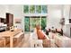An open-concept living room featuring modern decor, a fireplace, large windows, and access to an outdoor balcony at 1250 Lupo Loop, Palmetto, GA 30268