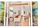 Open-concept living room and dining area with hardwood floors and large windows at 1250 Lupo Loop, Palmetto, GA 30268