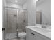Modern bathroom features a tiled shower with a glass door, vanity with a sink, and neutral color scheme at 4830 Briscoe Dr, Cumming, GA 30028