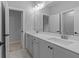 Stylish bathroom with double vanity, a large mirror, and modern fixtures, creating a spa-like experience at 4830 Briscoe Dr, Cumming, GA 30028