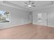 Spacious bedroom with light walls and hardwood floors leads to bathroom and outdoor deck at 4830 Briscoe Dr, Cumming, GA 30028