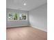 Inviting bedroom with ample natural light, neutral tones, and hardwood flooring for a cozy ambiance at 4830 Briscoe Dr, Cumming, GA 30028