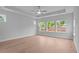 Bright bedroom boasts tray ceiling, ceiling fan, and large windows with ample natural light at 4830 Briscoe Dr, Cumming, GA 30028