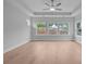 Bedroom with tray ceiling, ceiling fan, and large windows providing natural light at 4830 Briscoe Dr, Cumming, GA 30028