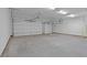 Spacious three-car garage with bright lighting and white doors at 4830 Briscoe Dr, Cumming, GA 30028