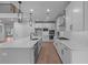 A modern kitchen with white cabinets, stainless steel appliances, and a large island with sink and marble counter at 4830 Briscoe Dr, Cumming, GA 30028