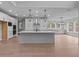 Spacious kitchen with a large island, stainless steel appliances, and abundant natural light at 4830 Briscoe Dr, Cumming, GA 30028