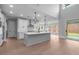 Bright kitchen features an island, stainless appliances, and views of the backyard at 4830 Briscoe Dr, Cumming, GA 30028