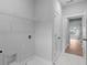 Practical laundry room with a sink, storage, and tiled flooring provides a functional and clean space at 4830 Briscoe Dr, Cumming, GA 30028