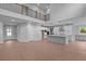 Open-concept living space with a modern kitchen, high ceilings, and natural light from the doorway and windows at 4830 Briscoe Dr, Cumming, GA 30028