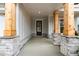 Covered porch with stone base columns and black front door at 4830 Briscoe Dr, Cumming, GA 30028