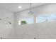 Modern tiled shower with glass partition and rainfall shower head at 4830 Briscoe Dr, Cumming, GA 30028