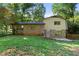 This backyard offers a well-manicured lawn, partial brick exterior, and tree coverage at 4883 Rock Haven Dr, Lilburn, GA 30047