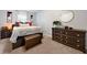 This bedroom features neutral walls, decorative wall hangings, and a dark wood dresser with round mirror at 4883 Rock Haven Dr, Lilburn, GA 30047