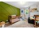 Bright bedroom featuring green accent wall, comfortable furnishings, and natural light at 4883 Rock Haven Dr, Lilburn, GA 30047