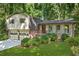 Charming home with a two-car garage, brick and siding accents, and landscaped front yard at 4883 Rock Haven Dr, Lilburn, GA 30047