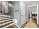 Inviting hallway with stairs and view into the kitchen with stainless steel appliances at 4883 Rock Haven Dr, Lilburn, GA 30047