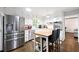 Bright kitchen featuring white cabinets, stainless steel appliances, and a functional kitchen island at 4883 Rock Haven Dr, Lilburn, GA 30047