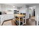 Open kitchen showcases white cabinetry, a functional island, and seamlessly connects to the living space at 4883 Rock Haven Dr, Lilburn, GA 30047