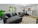 Spacious living area with a large sofa, natural light, and easy access to outdoor living space at 4883 Rock Haven Dr, Lilburn, GA 30047