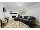 Cozy living room with a corner fireplace, a comfortable sectional sofa, and a stylish rug at 4883 Rock Haven Dr, Lilburn, GA 30047