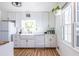 A bright kitchen features white cabinets and a large window over the sink at 3220 Toney Dr, Decatur, GA 30032