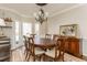 Dining room boasts a wooden table and chairs, elegant chandelier, and lots of natural light at 3834 Upland Dr, Marietta, GA 30066