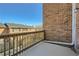 Cozy balcony with wooden railing overlooking the neighborhood under a clear blue sky at 6520 Roswell Rd # 79, Sandy Springs, GA 30328