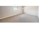 Bright, carpeted bedroom with a large window that lets in natural light at 6520 Roswell Rd # 79, Sandy Springs, GA 30328