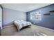 Cozy bedroom featuring neutral walls, soft carpeting, and a sunlit window at 6520 Roswell Rd # 79, Sandy Springs, GA 30328