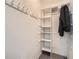 Bright closet offering built-in shelving with coat hooks and neutral carpeting at 6520 Roswell Rd # 79, Sandy Springs, GA 30328