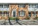 Brick townhouse featuring two stories, multiple windows, and a front door entrance at 6520 Roswell Rd # 79, Sandy Springs, GA 30328