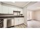 Galley kitchen with stainless appliances, white cabinets and modern faucet, with view to bonus space beyond at 6520 Roswell Rd # 79, Sandy Springs, GA 30328