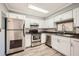Modern kitchen with white cabinets, stainless steel appliances, and tiled backsplash at 6520 Roswell Rd # 79, Sandy Springs, GA 30328