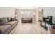 Bright living room featuring neutral paint, modern flooring, a bay window, and comfortable seating arrangements at 6520 Roswell Rd # 79, Sandy Springs, GA 30328