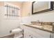 This bathroom features tiled walls, granite countertops, and modern fixtures at 1945 Dodson Sw Dr, Atlanta, GA 30311