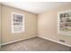 Comfortable bedroom with neutral walls, carpet, and large windows for natural light at 1945 Dodson Sw Dr, Atlanta, GA 30311