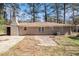 Backyard view of the brick home with a brick chimney and concrete patio at 1945 Dodson Sw Dr, Atlanta, GA 30311