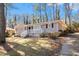 Well-maintained home featuring a front porch, brick facade, and driveway surrounded by mature trees at 1945 Dodson Sw Dr, Atlanta, GA 30311