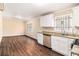 Bright kitchen with white cabinets, stainless steel appliances, and open floor plan at 1945 Dodson Sw Dr, Atlanta, GA 30311